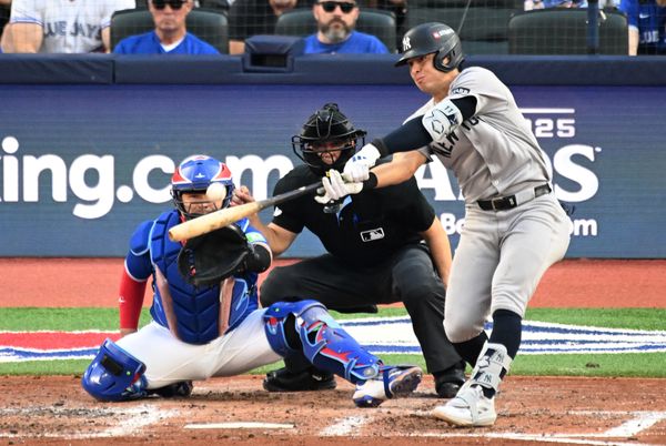 Oct 4, 2025; Toronto, Ontario, CAN; New York Yankees shortstop Anthony Volpe (11) doubles in the sixth inning in front of Toronto Blue Jays catcher Alejandro Kirk (30) during game one of the ALDS round for the 2025 MLB playoffs at Rogers Centre. Mandatory Credit: Dan Hamilton-Imagn Images