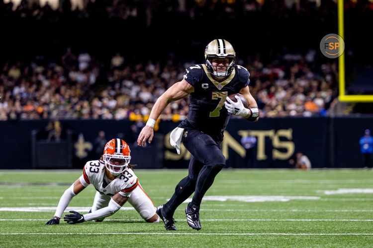 Nov 17, 2024; New Orleans, Louisiana, USA;  New Orleans Saints tight end Taysom Hill (7) avoids the tackle of Cleveland Browns safety Ronnie Hickman (33) during the second half at Caesars Superdome. Credit: Stephen Lew-Imagn Images