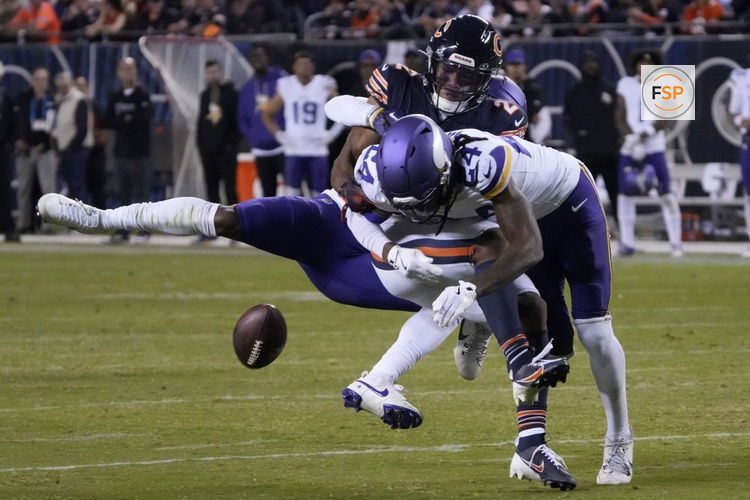 Sep 8, 2025; Chicago, Illinois, USA; Minnesota Vikings safety Jay Ward (24) knocks the ball from Chicago Bears wide receiver DJ Moore (2) during the second half at Soldier Field. Credit: David Banks-Imagn Images