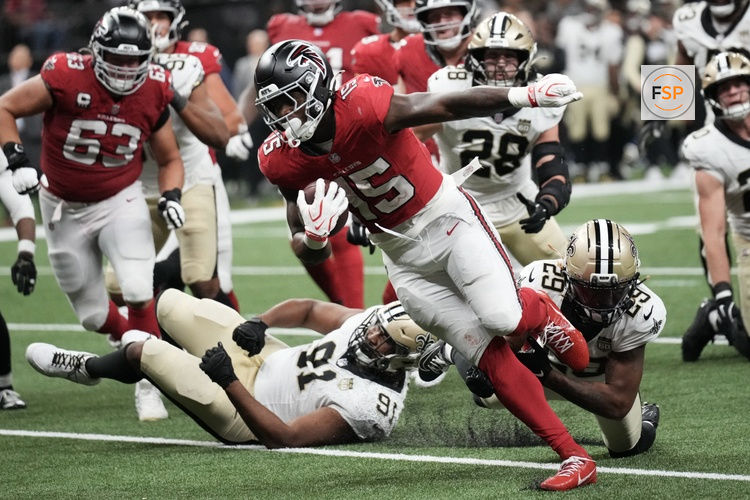 Oct 5, 2026; New Orleans, Louisiana, USA;  Atlanta Falcons running back Brian Robinson (15) runs to score a touchdown against New Orleans Saints defensive line Vernon Broughton (91) and cornerback Quincy Riley (29) in the during the second half at Caesars Superdome.  Credit: Matthew Hinton-Imagn Images
