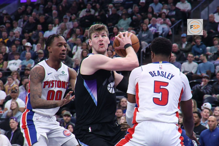 Mar 3, 2025; Salt Lake City, Utah, USA; Utah Jazz forward Kyle Filipowski (22) turns between Detroit Pistons forward Ronald Holland II (00) and guard Malik Beasley (5) during the second half at Delta Center. Credit: Rob Gray-Imagn Images