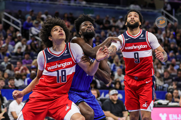 Feb 23, 2025; Orlando, Florida, USA; Washington Wizards forward Kyshawn George (18), forward Justin Champagnie (9) and Orlando Magic forward Jonathan Isaac (1) look for the rebound during the second half at Kia Center. Credit: Mike Watters-Imagn Images