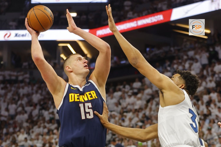 May 12, 2024; Minneapolis, Minnesota, USA; Denver Nuggets center Nikola Jokic (15) goes to the basket against Minnesota Timberwolves forward Karl-Anthony Towns (32) in the first quarter of game four of the second round for the 2024 NBA playoffs at Target Center. Credit: Bruce Kluckhohn-USA TODAY Sports