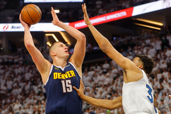 May 12, 2024; Minneapolis, Minnesota, USA; Denver Nuggets center Nikola Jokic (15) goes to the basket against Minnesota Timberwolves forward Karl-Anthony Towns (32) in the first quarter of game four of the second round for the 2024 NBA playoffs at Target Center. Mandatory Credit: Bruce Kluckhohn-USA TODAY Sports