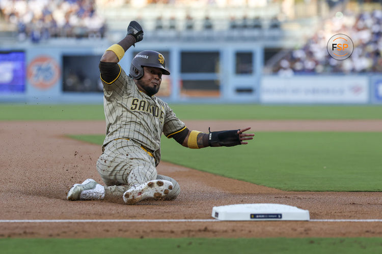 Oct 5, 2024; Los Angeles, California, USA; San Diego Padres first baseman Luis Arraez (4) slides in the first inning against the Los Angeles Dodgers during game one of the NLDS for the 2024 MLB Playoffs at Dodger Stadium. Credit: Kiyoshi Mio-Imagn Images