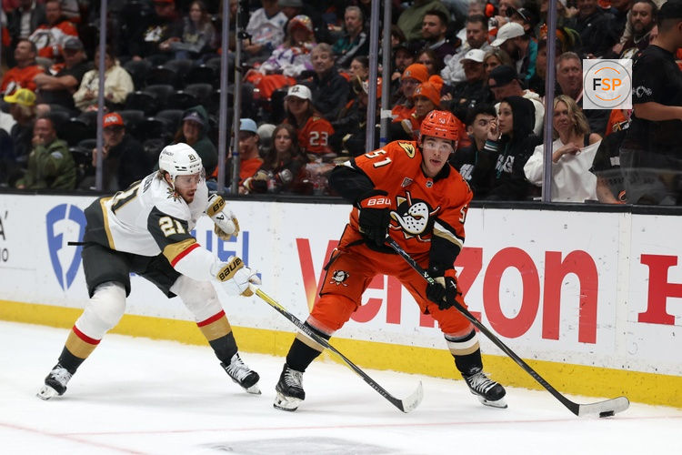 May 14, 2026; Anaheim, California, USA; Anaheim Ducks defenseman Olen Zellweger (51) controls the puck past Vegas Golden Knights center Brett Howden (21) during the third period in game six of the second round of the 2026 Stanley Cup Playoffs at Honda Center. Credit: Kiyoshi Mio-Imagn Images