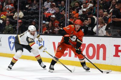 May 14, 2026; Anaheim, California, USA; Anaheim Ducks defenseman Olen Zellweger (51) controls the puck past Vegas Golden Knights center Brett Howden (21) during the third period in game six of the second round of the 2026 Stanley Cup Playoffs at Honda Center. Mandatory Credit: Kiyoshi Mio-Imagn Images