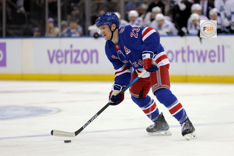 Jan 5, 2026; New York, New York, USA; New York Rangers defenseman Adam Fox (23) skates with the puck against the Utah Mammoth during the second period at Madison Square Garden. Credit: Brad Penner-Imagn Images
