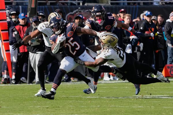 Oct 19, 2025; Chicago, Illinois, USA; New Orleans Saints safety Justin Reid (21) makes a diving tackle against Chicago Bears running back Kyle Monangai (25) during the second half at Soldier Field. Mandatory Credit: David Banks-Imagn Images