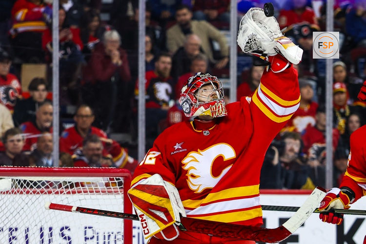 Apr 15, 2025; Calgary, Alberta, CAN; Calgary Flames goaltender Dustin Wolf (32) makes a save against the Vegas Golden Knights during the third period at Scotiabank Saddledome. Credit: Sergei Belski-Imagn Images