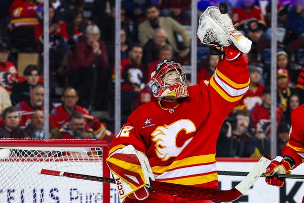 Apr 15, 2025; Calgary, Alberta, CAN; Calgary Flames goaltender Dustin Wolf (32) makes a save against the Vegas Golden Knights during the third period at Scotiabank Saddledome. Mandatory Credit: Sergei Belski-Imagn Images