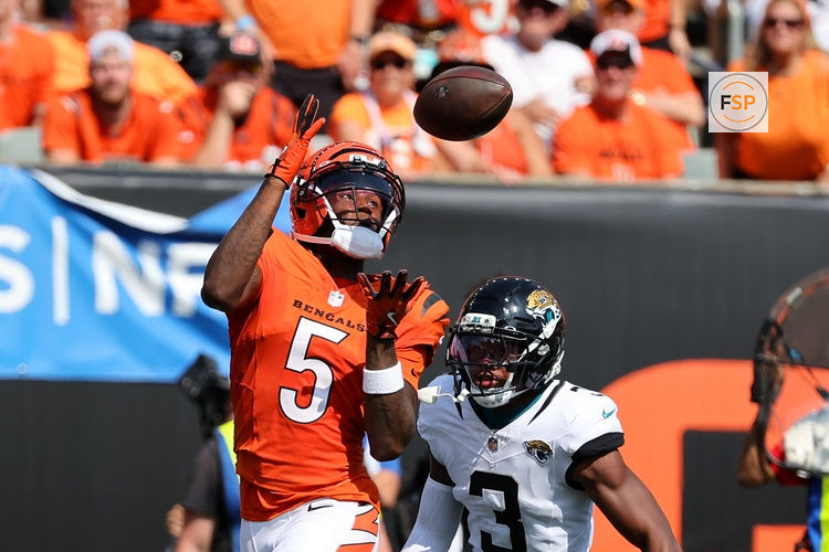 Sep 14, 2025; Cincinnati, Ohio, USA;  Cincinnati Bengals wide receiver Tee Higgins (5) catches the touchdown  pass over Jacksonville Jaguars cornerback Tyson Campbell (3) during the fourth quarter at Paycor Stadium. Credit: Joseph Maiorana-Imagn Images