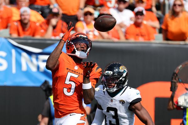 Sep 14, 2025; Cincinnati, Ohio, USA;  Cincinnati Bengals wide receiver Tee Higgins (5) catches the touchdown  pass over Jacksonville Jaguars cornerback Tyson Campbell (3) during the fourth quarter at Paycor Stadium. Mandatory Credit: Joseph Maiorana-Imagn Images
