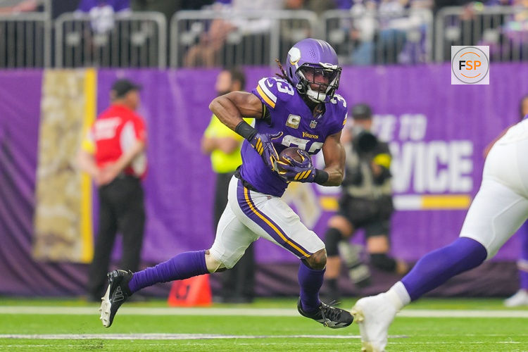 Nov 9, 2025; Minneapolis, Minnesota, USA; Minnesota Vikings running back Aaron Jones Sr. (33) runs with the ball against the Baltimore Ravens in the second quarter at U.S. Bank Stadium. Credit: Brad Rempel-Imagn Images