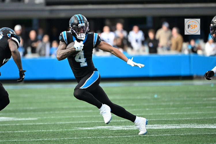 Dec 21, 2025; Charlotte, North Carolina, USA; Carolina Panthers wide receiver Tetairoa McMillan (4) with the ball in the third quarter at Bank of America Stadium. Credit: Bob Donnan-Imagn Images