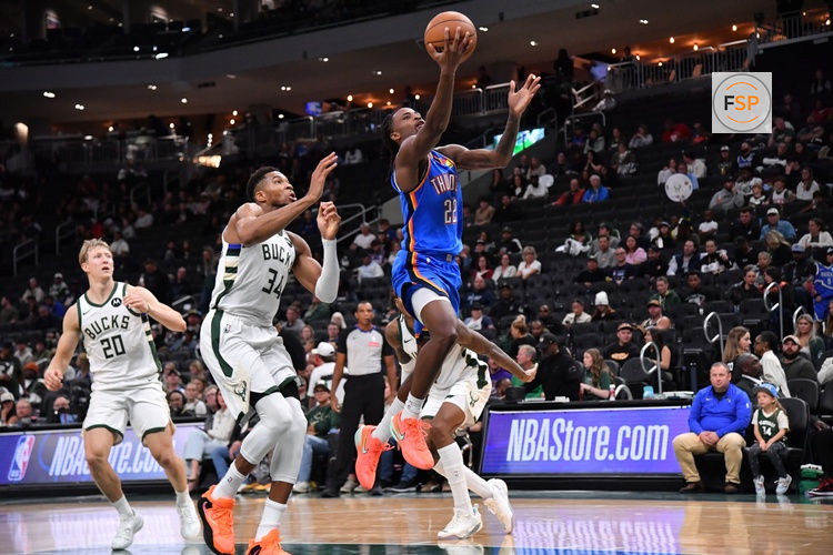 Oct 14, 2025; Milwaukee, Wisconsin, USA; Oklahoma City Thunder guard Cason Wallace (22) goes up for a shot against Milwaukee Bucks forward Giannis Antetokounmpo (34) during the second half at Fiserv Forum. Credit: Patrick Gorski-Imagn Images