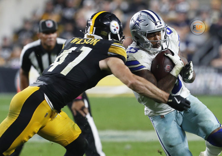 Oct 6, 2024; Pittsburgh, Pennsylvania, USA;  Dallas Cowboys running back Rico Dowdle (23) runs the ball against Pittsburgh Steelers linebacker Payton Wilson (41) during the fourth quarter at Acrisure Stadium. Dallas won 20-17. Credit: Charles LeClaire-Imagn Images