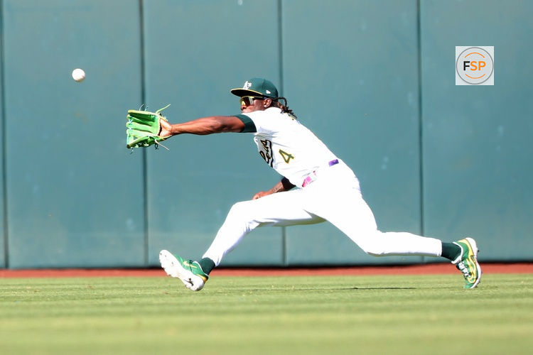Sep 14, 2025; West Sacramento, California, USA; Athletics center fielder Lawrence Butler (4) catches a line drive against the Cincinnati Reds and ends the game at Sutter Health Park. Credit: Dennis Lee-Imagn Images