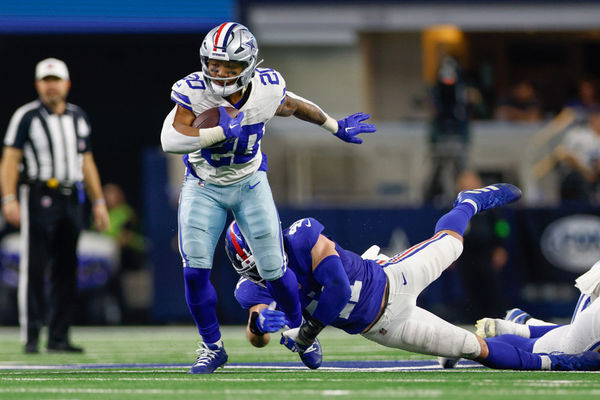 ARLINGTON, TX - NOVEMBER 12: Dallas Cowboys running back Tony Pollard (20) breaks free from a tackle attempt by New York Giants linebacker Micah McFadden (41) during the game between the Dallas Cowboys and New York Giants on November 12, 2023 at AT&T Stadium in Arlington, TX. (Photo by Andrew Dieb/Icon Sportswire)