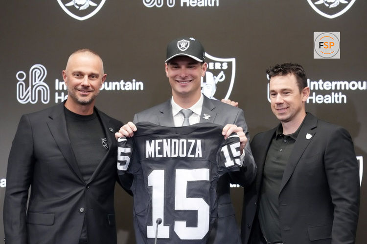 Apr 24, 2026; Henderson, NV, USA; Las Vegas Raiders quarterback Fernando Mendoza (center) poses with jersey with general manager John Spytek (left) and head coach Klint Kubiak  at introductory press conference at Intermountain Health Performance Center after being selected as the No. 1 pick in the 2026 NFL Draft. Credit: Kirby Lee-Imagn Images