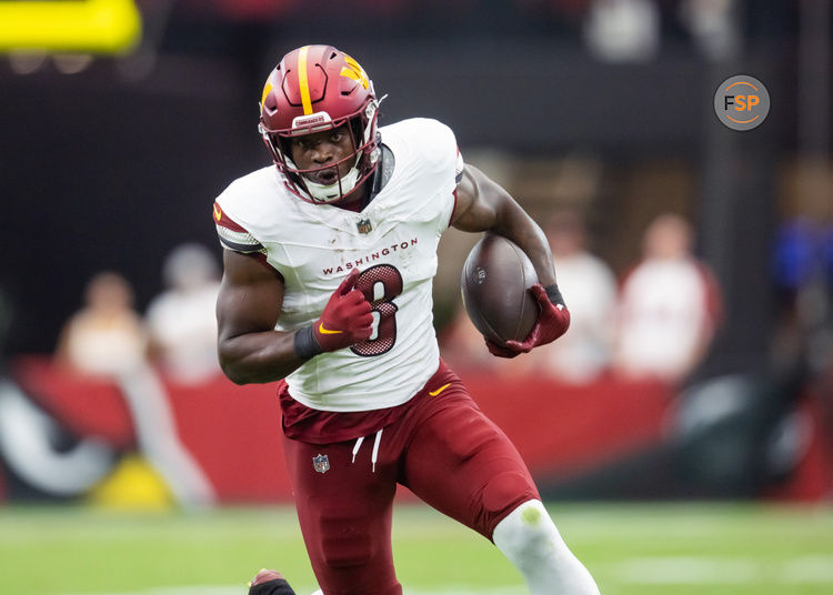 Sep 29, 2024; Glendale, Arizona, USA; Washington Commanders running back Brian Robinson Jr. (8) against the Arizona Cardinals at State Farm Stadium. Credit: Mark J. Rebilas-Imagn Images