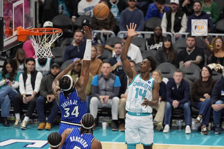 Oct 30, 2025; Charlotte, North Carolina, USA; Charlotte Hornets forward Moussa Diabate (14) shoots the ball over Orlando Magic center Wendell Carter Jr. (34) during the second half at Spectrum Center. Credit: Jim Dedmon-Imagn Images