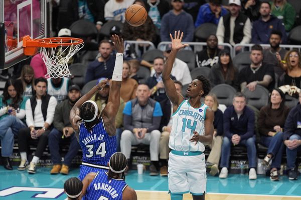 Oct 30, 2025; Charlotte, North Carolina, USA; Charlotte Hornets forward Moussa Diabate (14) shoots the ball over Orlando Magic center Wendell Carter Jr. (34) during the second half at Spectrum Center. Mandatory Credit: Jim Dedmon-Imagn Images