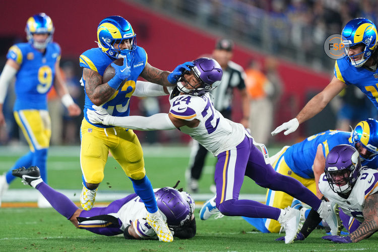 Jan 13, 2025; Glendale, AZ, USA; Los Angeles Rams running back Kyren Williams (23) rushes the ball against Minnesota Vikings safety Camryn Bynum (24) during the first half in an NFC wild card game at State Farm Stadium. Credit: Joe Camporeale-Imagn Images