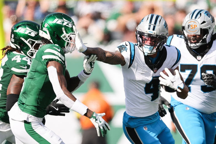 Oct 19, 2025; East Rutherford, New Jersey, USA; Carolina Panthers wide receiver Tetairoa McMillan (4) stiff arms New York Jets cornerback Sauce Gardner (1) in the second quarter at MetLife Stadium. Credit: Vincent Carchietta-Imagn Images