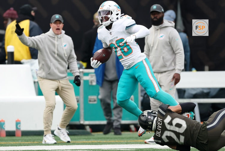 Dec 7, 2025; East Rutherford, New Jersey, USA; New York Jets safety Isaiah Oliver (26) tackles Miami Dolphins running back De'Von Achane (28) during the first half at MetLife Stadium. Credit: Vincent Carchietta-Imagn Images
