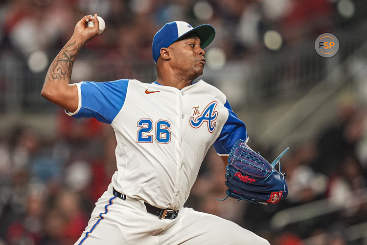 Sep 28, 2024; Cumberland, Georgia, USA; Atlanta Braves relief pitcher Raisel Iglesias (26) pitches against the Kansas City Royals during the ninth inning at Truist Park. Credit: Dale Zanine-Imagn Images