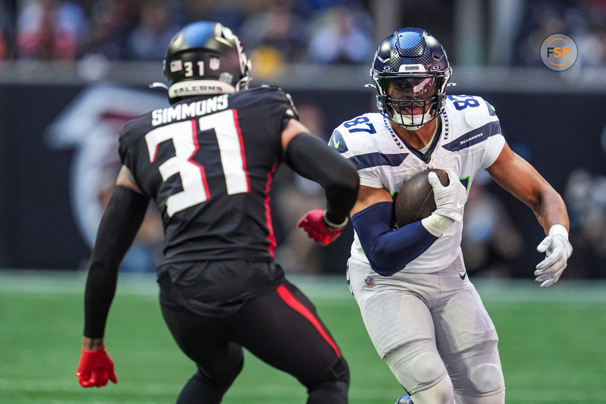 Oct 20, 2024; Atlanta, Georgia, USA; Seattle Seahawks tight end Noah Fant (87) runs against Atlanta Falcons safety Justin Simmons (31) during the first half at Mercedes-Benz Stadium. Credit: Dale Zanine-Imagn Images