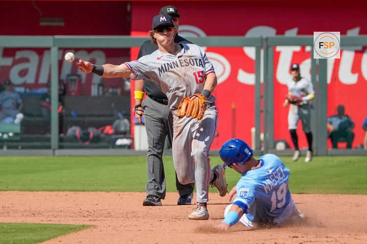 Sep 7, 2025; Kansas City, Missouri, USA; Minnesota Twins second baseman Luke Keaschall (15) gets the out on Kansas City Royals second baseman Michael Massey (19) at second base and throws to first during the seventh inning at Kauffman Stadium. Credit: Denny Medley-Imagn Images