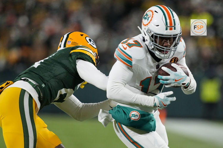 Nov 28, 2024; Green Bay, Wisconsin, USA;  Miami Dolphins wide receiver Jaylen Waddle (17) rushes with the football after catching a pass during the second quarter against the Green Bay Packers at Lambeau Field. Credit: Jeff Hanisch-Imagn Images