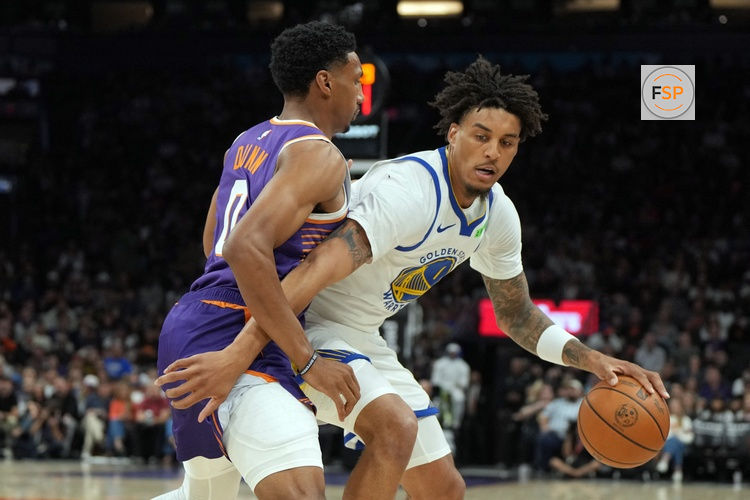 Oct 24, 2026; Phoenix, Arizona, USA;  Golden State Warriors forward Yaxel Lendeborg (1) shields the ball from Phoenix Suns forward Ryan Dunn (0) in the first half at Mortgage Matchup Center.  Credit: Rick Scuteri-Imagn Images