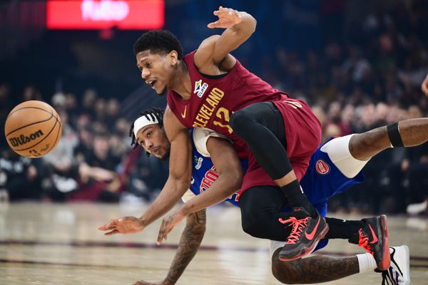 Jan 4, 2026; Cleveland, Ohio, USA; Cleveland Cavaliers forward De'andre Hunter (12) goes for a loose ball against  Detroit Pistons forward Ronald Holland II (5) during the first half at Rocket Arena. Mandatory Credit: Ken Blaze-Imagn Images