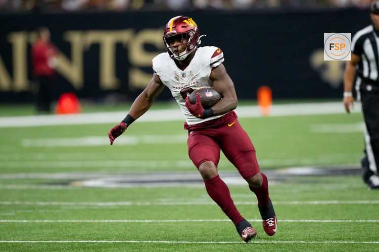Dec 15, 2024; New Orleans, Louisiana, USA; Washington Commanders running back Brian Robinson Jr. (8) runs against the New Orleans Saints during the first half at Caesars Superdome. Credit: Matthew Hinton-Imagn Images
