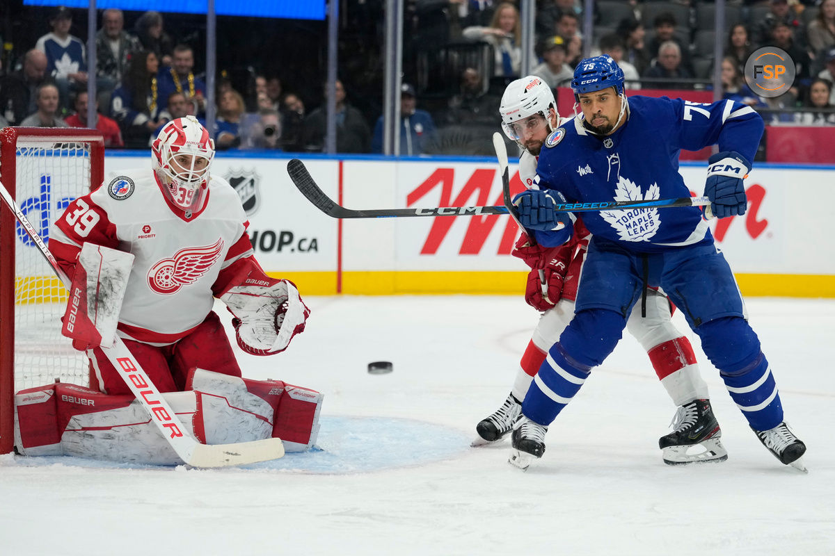 Nov 8, 2024; Toronto, Ontario, CAN; Toronto Maple Leafs forward Ryan Reaves (75) tries to deflect a puck against Detroit Red Wings goaltender Cam Talbot (39) during the third period at Scotiabank Arena. Credit: John E. Sokolowski-Imagn Images