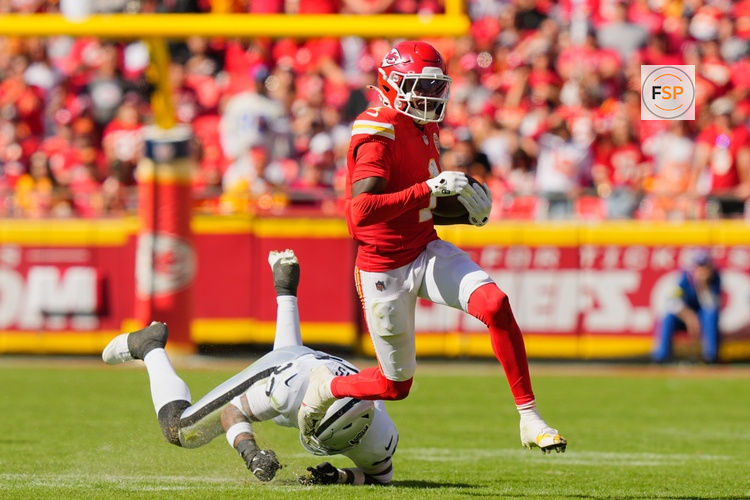 Oct 19, 2025; Kansas City, Missouri, USA; Kansas City Chiefs wide receiver Xavier Worthy (1) avoids a tackle by Las Vegas Raiders linebacker Jamal Adams (33) during the third quarter of the game at GEHA Field at Arrowhead Stadium. Credit: Jay Biggerstaff-Imagn Images