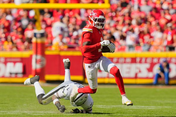Oct 19, 2025; Kansas City, Missouri, USA; Kansas City Chiefs wide receiver Xavier Worthy (1) avoids a tackle by Las Vegas Raiders linebacker Jamal Adams (33) during the third quarter of the game at GEHA Field at Arrowhead Stadium. Mandatory Credit: Jay Biggerstaff-Imagn Images