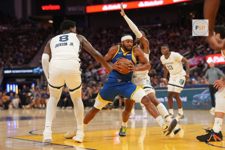 Oct 27, 2025; San Francisco, California, USA; Golden State Warriors guard Moses Moody (4) drives to the hoop between Memphis Grizzlies forward Jaren Jackson Jr. (8) and guard Ja Morant (12) in the third quarter at the Chase Center. Credit: Cary Edmondson-Imagn Images