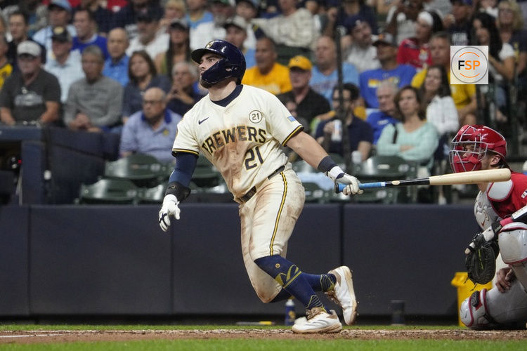 Sep 16, 2025; Milwaukee, Wisconsin, USA; Milwaukee Brewers third base Caleb Durbin (21) gets a base hit against the Los Angeles Angels in the third inning at American Family Field. Credit: Michael McLoone-Imagn Images