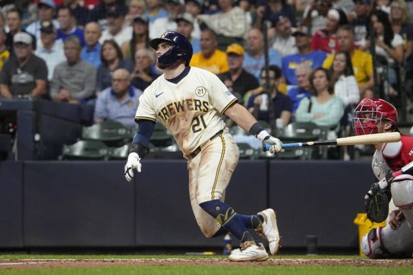 Sep 16, 2025; Milwaukee, Wisconsin, USA; Milwaukee Brewers third base Caleb Durbin (21) gets a base hit against the Los Angeles Angels in the third inning at American Family Field. Mandatory Credit: Michael McLoone-Imagn Images