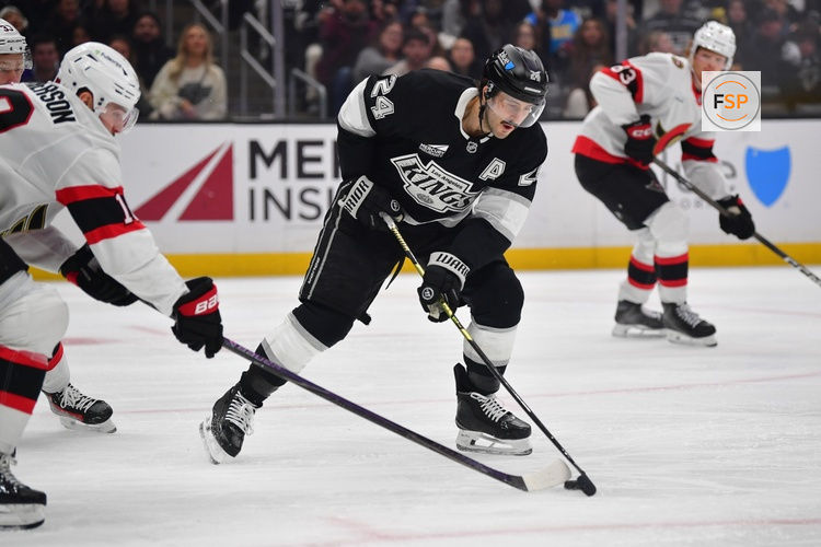 Nov 24, 2025; Los Angeles, California, USA; Los Angeles Kings center Phillip Danault (24) plays for the puck against Ottawa Senators center Tim Stutzle (18) during the second period at Crypto.com Arena. Credit: Gary A. Vasquez-Imagn Images