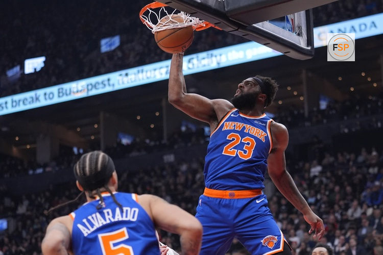 Mar 3, 2026; Toronto, Ontario, CAN; New York Knicks center Mitchell Robinson (23) shoots against the Toronto Raptors during the first half at Scotiabank Arena. Credit: John E. Sokolowski-Imagn Images