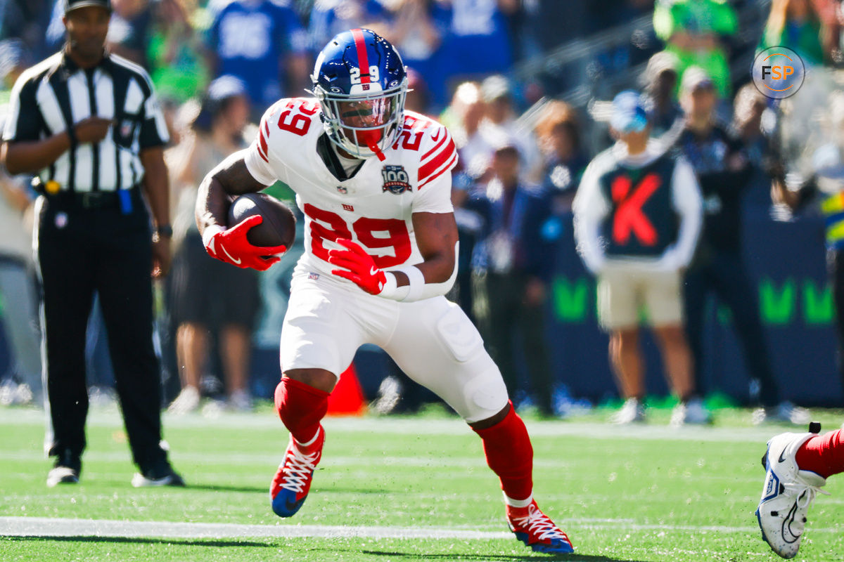 Oct 6, 2024; Seattle, Washington, USA; New York Giants running back Tyrone Tracy Jr. (29) rushes against the Seattle Seahawks during the first quarter at Lumen Field. Credit: Joe Nicholson-Imagn Images