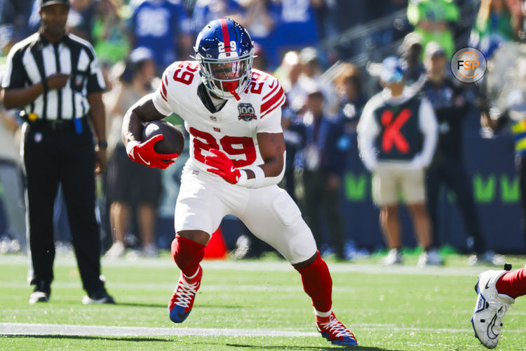 Oct 6, 2024; Seattle, Washington, USA; New York Giants running back Tyrone Tracy Jr. (29) rushes against the Seattle Seahawks during the first quarter at Lumen Field. Credit: Joe Nicholson-Imagn Images