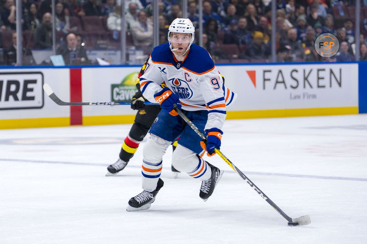 Jan 18, 2025; Vancouver, British Columbia, CAN; Edmonton Oilers forward Connor McDavid (97) handles the puck against the Vancouver Canucks in the first period at Rogers Arena. Credit: Bob Frid-Imagn Images