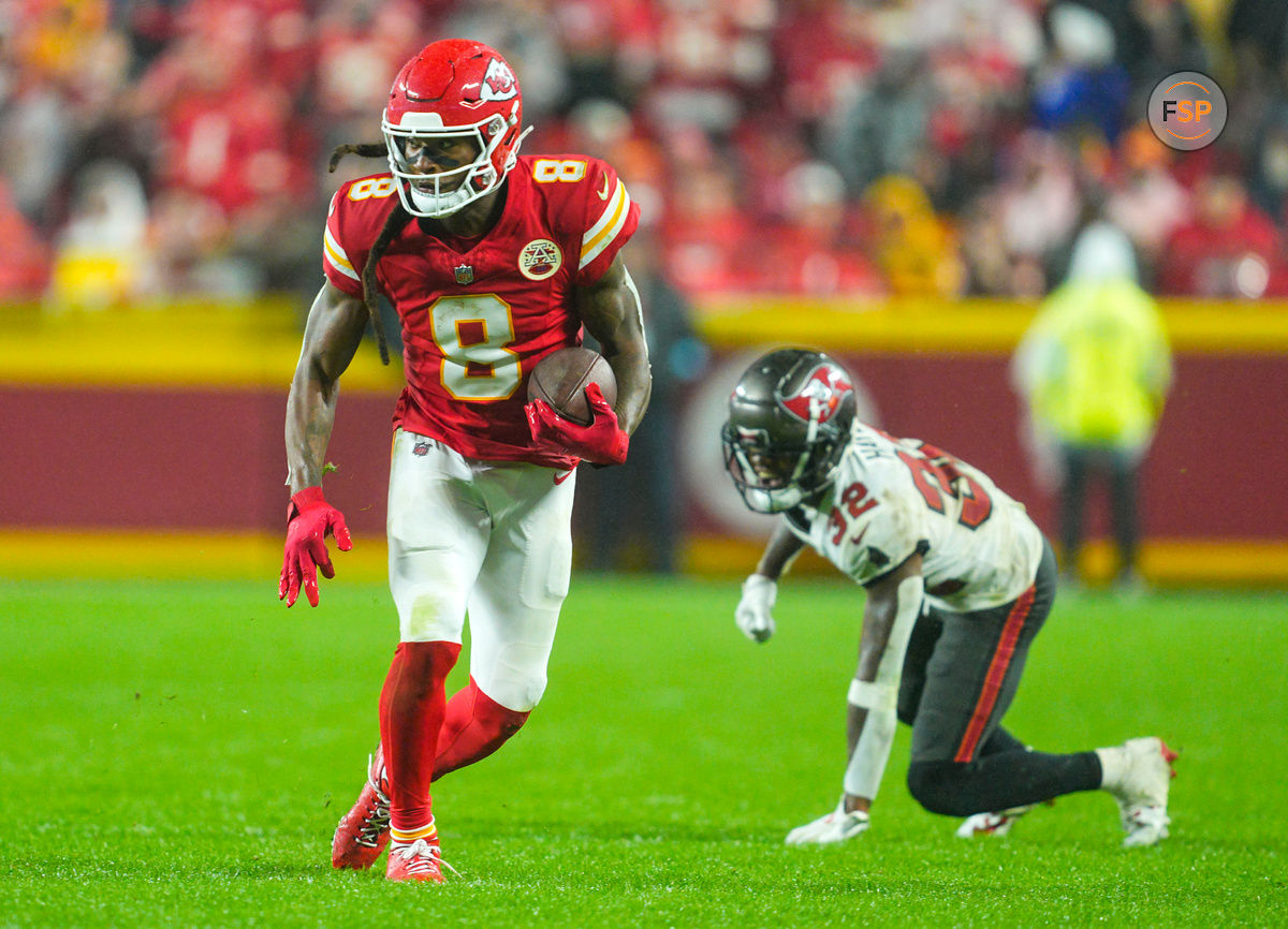 Nov 4, 2024; Kansas City, Missouri, USA; Kansas City Chiefs wide receiver DeAndre Hopkins (8) runs with the ball past Tampa Bay Buccaneers safety Josh Hayes (32) during overtime at GEHA Field at Arrowhead Stadium. Credit: Jay Biggerstaff-Imagn Images