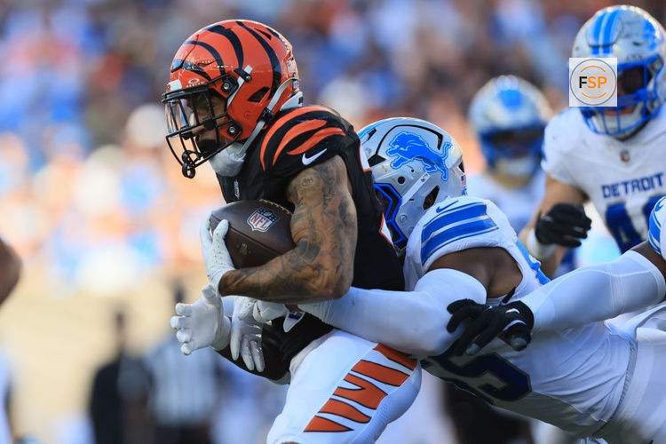 Oct 5, 2025; Cincinnati, Ohio, USA; Cincinnati Bengals running back Chase Brown (30) is tackled by Detroit Lions linebacker Derrick Barnes (55) during the second quarter at Paycor Stadium. Credit: Katie Stratman-Imagn Images